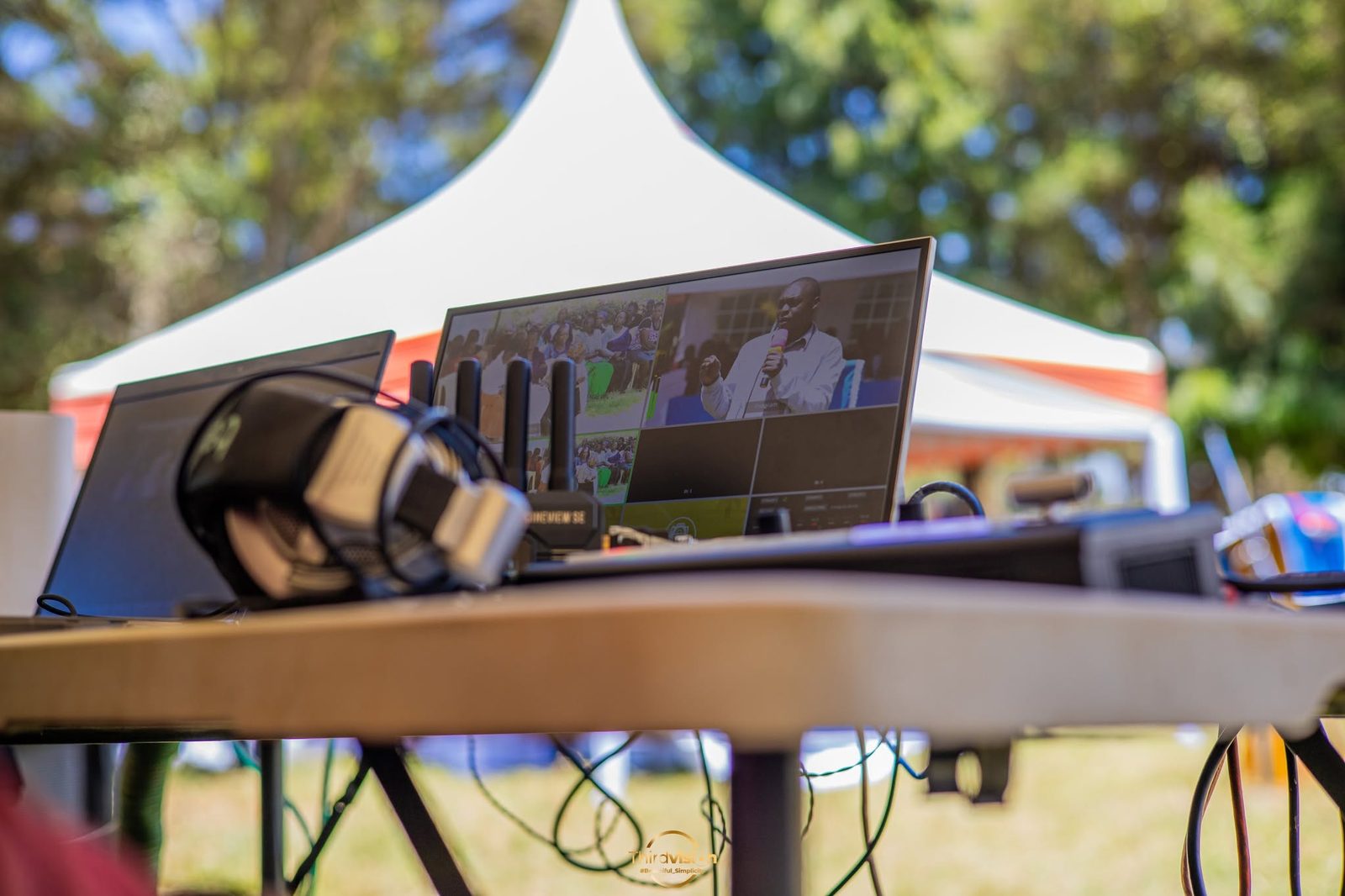 Livestream monitoring set up under a tent at an outdoor event