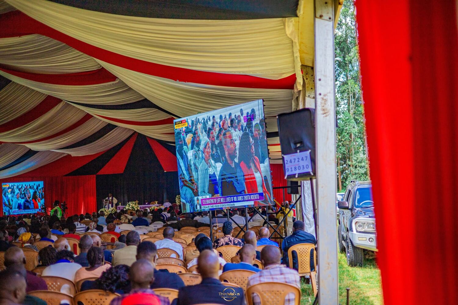 Event screens relaying the stage to a full seated crowd